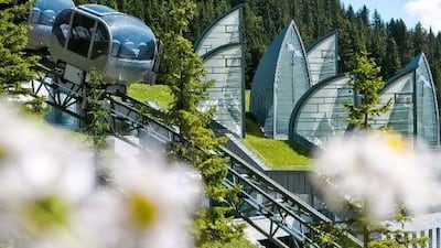The Tschuggen Express, a small train that looks like a posh roller coaster, zips past the Tschuggen Grand Hotel in Arosa, Switzerland. Courtesy of the Leading Hotels of the World