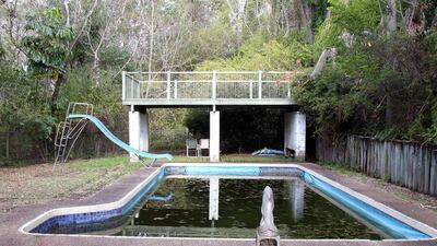 A stagnant swimming pool at the home of Marguerite Thoresen in Brisbane, Australia. Thoresen's mother, Cynthia, who lived at the house, died a week before her 89th birthday in a condition that suggested a "severe degree of neglect...to the point of cruelty in a distressed, demented and totally dependent patient". Tertius Pickard / AP
