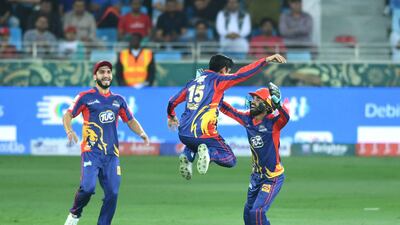 Karachi Kings players celebrate the dismissal of a Lahore Qalandars batsman.