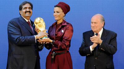 Qatar's Emir Sheikh Hamad bin Khalifa Al Thani (R) and his wife Sheikha Moza bint Nasser Al Missned (C) receive the World Cup trophy from Fifa president Joseph Blatter after the official announcement that Qatar will host the 2022 World Cup at the Fifa headquarters in Zurich on December 2, 2010. Fabrice Coffrini / AFP Photo