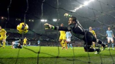 Manchester City's Gareth Barry scores a header past Reading goalkeeper Adam Federici. Julian Finney / Getty Images;