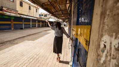 A Syrian Kurdish ballet dancer performs in an empty market during lockdown in Syria's northeastern city of Qamishli. AFP