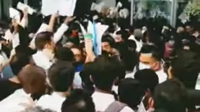 Jobseekers wave their CVs outside the Vida Emirates Hills Hotel on Saturday Photo: Sai Sagar