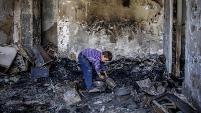 An Afghan child stands in his damaged room in Kabul. EPA