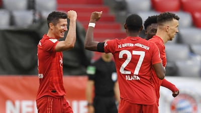 Robert Lewandowski celebrates scoring Bayern's third goal with David Alaba. Reuters