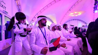 An aspiring young astronaut and her family at the Mohammed bin Rashid Space Centre event. Chris Whiteoak / The National
