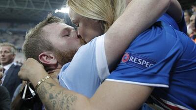 Iceland's Aron Gunnarsson, left, gets a kiss at the end of the Euro 2016 round of 16 soccer match between England and Iceland, at the Allianz Riviera stadium in Nice, France, Monday, June 27, 2016. Iceland won 2-1. (AP Photo/Thanassis Stavrakis)
