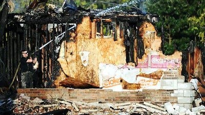 A firefighter works to extinguish the smouldering remains of the Joplin mosque. The August 6 fire was the second to hit the Islamic centre in little more than a month.