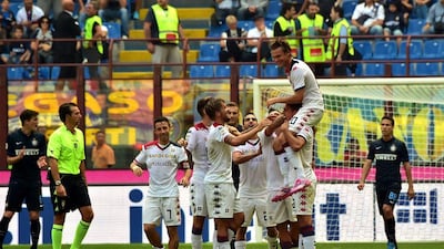 Cagliari's Swedish forward Albin Ekdal top, celebrates with his teammates following one of his three goals against Inter Milan on Sunday in a Serie A victory. Giuseppe Cacace / AFP / September 28, 2014