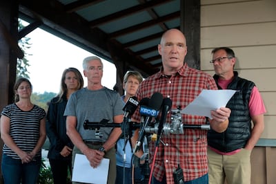 Mike Mathews and friends of Richard Russell talk to the media on Saturday, August 11, 2018, at the Orting Valley Police and Fire Department, in Orting, Washington. Bettina Hansen / The Seattle Times via AP