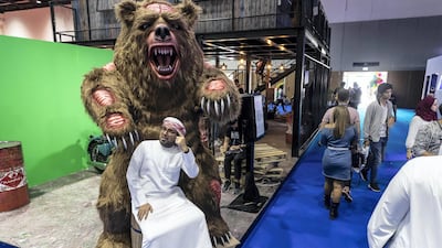 A Comic Con goer poses with an enormous bear. Antonie Robertson / The National