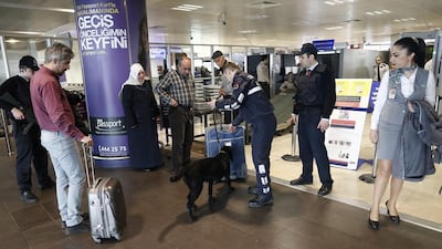 Police with a K-9 dog search luggage at Ataturk airport in Istanbul. Security was tightened across transport links after terrorists carried out attacks at Brussels airport and the metro system. Sedat Una / EPA