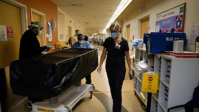 Chaplain Kristin Michealsen leaves a Covid-19 unit after talking to a family member of a deceased patient at Providence Holy Cross Medical Center in the Mission Hills section of Los Angeles. AP Photo
