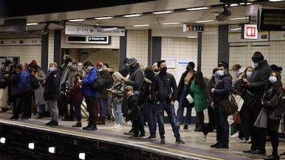 Passengers wait on the platform at Victoria London Underground station in central London. AFP