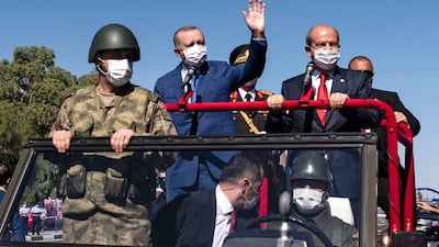 Turkish Cypriot leader Ersin Tatar and Turkish President Recep Tayyip Erdogan wave as they take part in a parade in the northern part of Cyprus's divided capital Nicosia. AFP