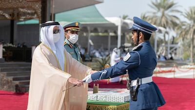 Sheikh Saif hands the sword of honour to cadet Mohamed Al Qorsi Al Ali, who graduated first in his class for total marks, academic sciences and special training. Wam