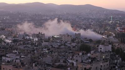 Smoke billows as Israeli soldiers demolish a house at the Asker camp for Palestinian refugees, near Nablus in the occupied West Bank. AFP