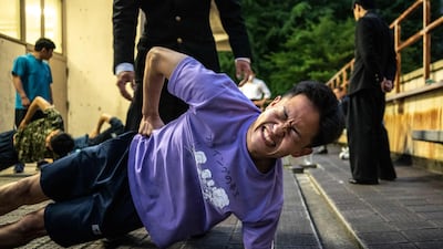 Taiga Kobayashi, a member of the Meiji University 'oendan', during a warm-up workout before clapping practice at the campus in Tokyo