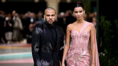 Football player Dani Alves and his wife, Joana Sanz, step on to the green carpet. Reuters