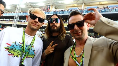 Rockers Dom Howard, Jared Leto and Matt Bellamy pose for a photo on the grid prior to the F1 Grand Prix of Abu Dhabi at Yas Marina Circuit. Getty Images