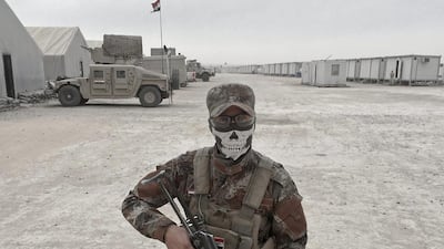 Loay Mahdi, from Kirkuk, an Iraqi army soldier, poses for a portrait at the Qayara West Coalition base in Qayara.