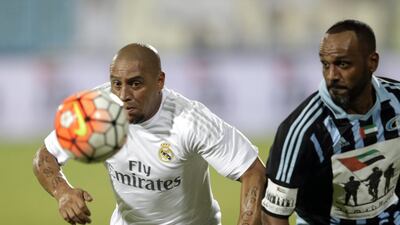 Real Madrid Legends’ defender Roberto Carlos of Brazil, left, in action against a team of Baniyas Legends sat Baniyas Stadium. Ali Haider / EPA