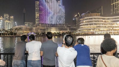 The faces of all nine members of Exo were shown on the facade of the Burj Khalifa during the three minute show. Antonie Robertson / The National