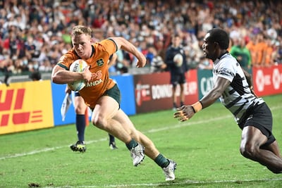 Australia’s Henry Hutchison, left, heads for a try as Fiji’s Josevani Soro attempts a tackle in the Hong Kong Sevens men's final on November 6, 2022. AFP