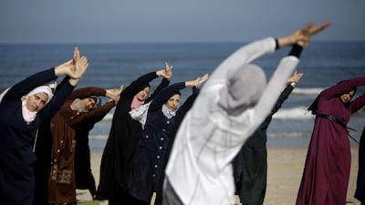 Palestinian women practise yoga on the beach in Gaza City during an event organised by the the Positive Energy Club. AFP