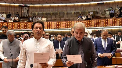Newly elected parliamentarian Imran Khan, left, takes the oath of office with Shah Mehmood Qureshi, in Islamabad, Pakistan. AP