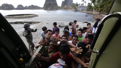 Filipino victims of Super Typhoon Haiyan rush to receive relief goods transported by the Philippine Air Force Sokol 550th Search and Rescue Group in a remote village in eastern Samar province. Dennis Sabangan / EPA