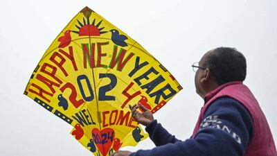 A man flies a decorated kite to mark New Year's Eve in Amritsar. AFP
