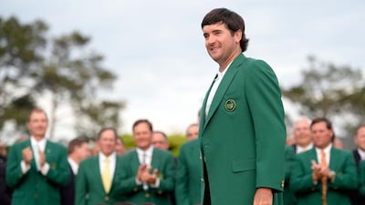 Bubba Watson of the United States poses with the green jacket after winning the 2014 Masters Tournament by a three-stroke margin at Augusta National Golf Club on April 13, 2014 in Augusta, Georgia. Harry How/Getty Images