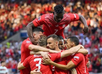 Switzerland forward Haris Seferovic, centre, celebrates with teammates after scoring against Portugal. EPA