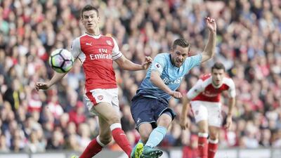 Swansea’s Gylfi Sigurosson, right, scores a goal past Arsenal’s Laurent Koscielny during their match at Emirates Stadium in London,on Oct. 15, 2016. Tim Ireland / AP Photo