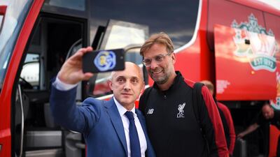 A handout photo made available by the UEFA of Liverpool's manager Juergen Klopp (R) posing for a selfie as he arrives ahead of the UEFA Champions League final at IEV Airport in Kiev, Ukraine. EPA / UEFA / HANDOUT