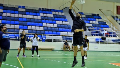 Reyadh, centre, oversees a training session in Manama.