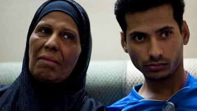 Iraqi Palestinian refugees Nahya Mahmoud Abdulkader (left) and her disabled son, Omar, in a Damascus refugee camp.