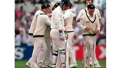 England batsman Mike Gatting looks down at the stumps after being bowled out by the Australian spinner Shane Warne.
