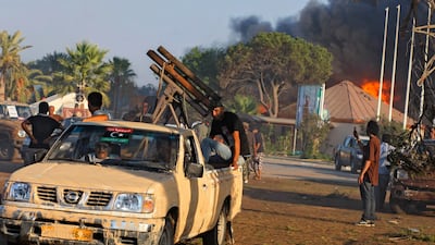 Rebel fighters drive their vehicle inside the main Moammar Gadhafi compound in Bab Aa-Aziziya in Tripoli, LIbya, Tuesday, Aug. 23, 2011. Libyan rebels stormed Moammar Gadhafi's main military compound in Tripoli Tuesday after fierce fighting with forces lo???