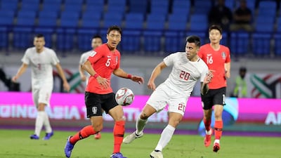Jung Woo-young, No 5, of South Korea and the Philippines' Javier Patino, No 20, in action during their Asian Cup game.
