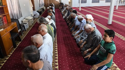 Syrian refugees pray in a mosque at the camp. Getty Images