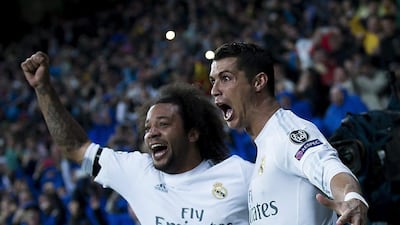 Cristiano Ronaldo (R) of Real Madrid CF celebrates scoring their third goal with teammate Marcelo (L) during the UEFA Champions League quarter final second leg match between Real Madrid CF and VfL Wolfsburg at Estadio Santiago Bernabeu on April 12, 2016 in Madrid, Spain. Gonzalo Arroyo Moreno/Getty Images