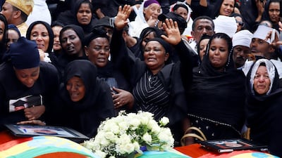 Mourners cry next to their relatives' coffins during the burial ceremony of the Ethiopian Airline Flight ET 302 crash victims at the Holy Trinity Cathedral Orthodox church in Addis Ababa, Ethiopia. Reuters