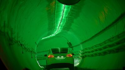 A modified Tesla Model X drives in the tunnel entrance. EPA