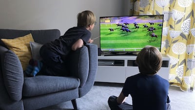 Kids watch the virtual Grand National in Wallington. Getty Images