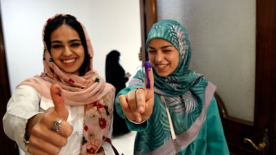 Lebanese girls residing in Iran show their inked fingers after casting their votes during the parliamentary elections at a polling station at the Lebanon embassy in Tehran, Iran. EPA