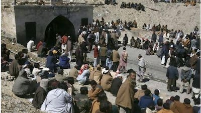 Relatives, friends and neighbours gather yesterday around the entrance to a coal mine which has claimed at least seven miners at a site east of Quetta, in the Baluchistan province of Pakistan. Reuters