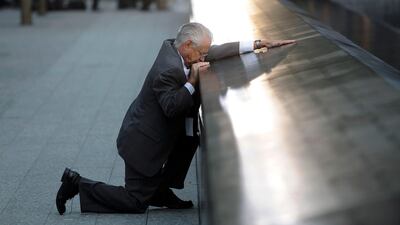 Robert Peraza, who lost his son Robert David Peraza, pauses at his son's name at the North Pool of the 9/11 Memorial during tenth anniversary ceremonies at the site of the World Trade Center in New York, September 11, 2011. The 9/11 attacks changed life in the United States forever, but 10 years after the devastating hit, New Yorkers have learned to live in a more dangerous world and are ready to move on. Reuters