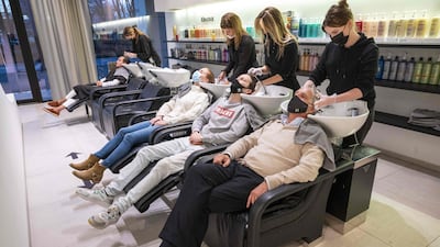 Hairdressers and clients wear masks in Amsterdam, Netherlands. AFP